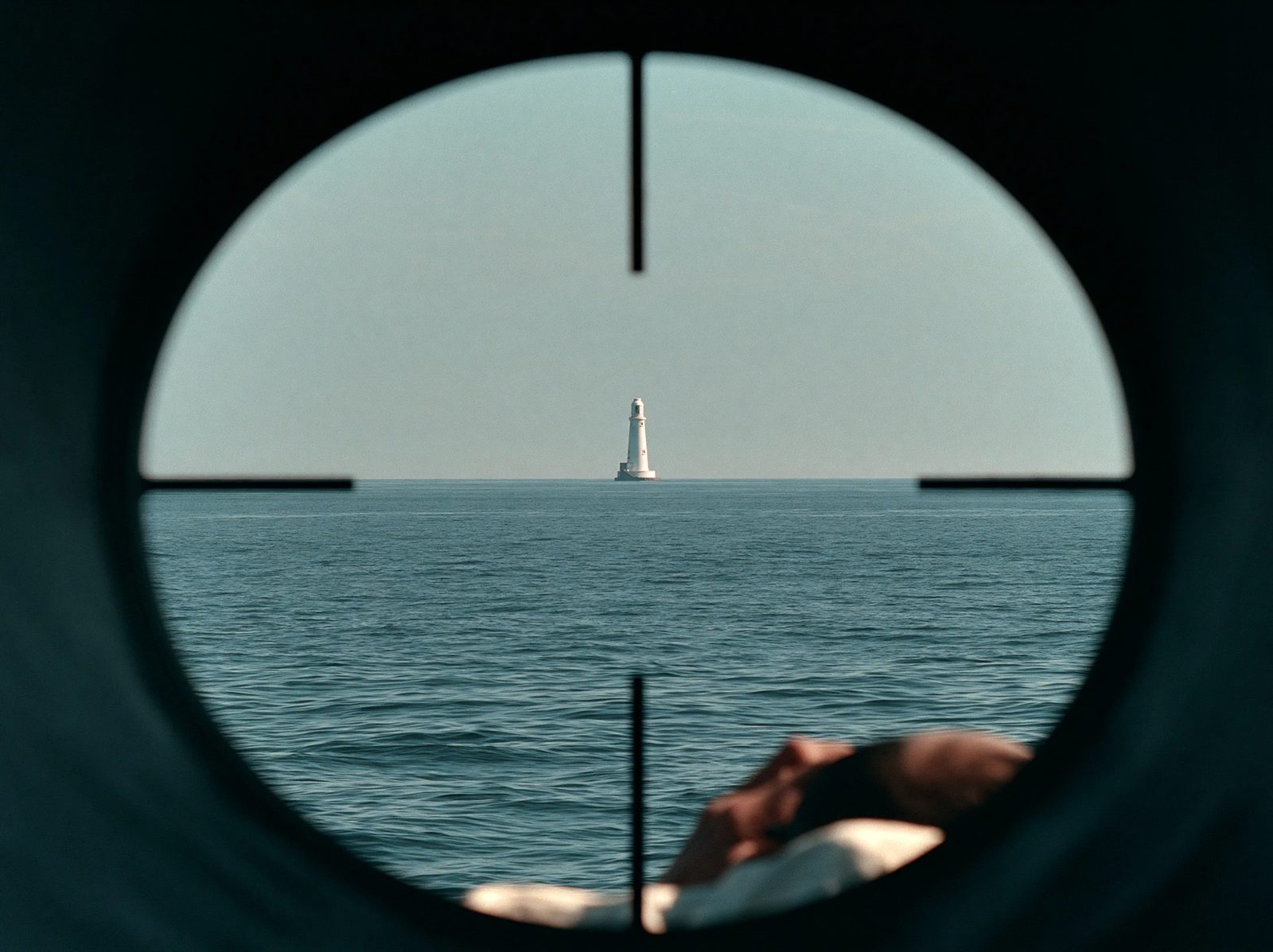 A periscope view of a distant lighthouse on a calm sea, with a crosshair reticle overlay, shot on 35mm film --ar 4:3