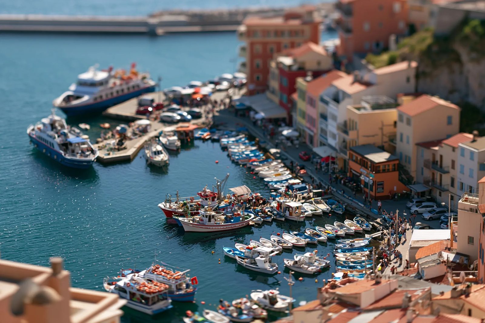 Midjourney Demo Prompt: a busy harbor town from a high clifftop, tilt-shift miniature, one razor-thin band of focus across the tiny boats and quay, everything above and below melting to blur, toy-like clarity, bright noon color --ar 3:2 --style raw --s 100 --preview