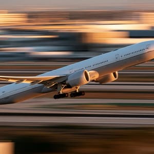 airplane, A high-speed panning shot of a commercial passenger jet during takeoff, with the runway lines beautifully blurred into horizontal motion streaks.