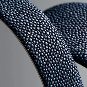 A luxury watch strap made from rich deep indigo pebbled shagreen, showcasing the distinct glossy beaded texture.