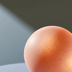 A minimalist designer table lamp made of soft peach-toned silicone, emitting a warm subsurface dermal glow from within.