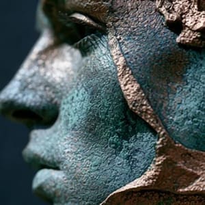 A classical copper bust covered in a rich, textured verdigris patina.
