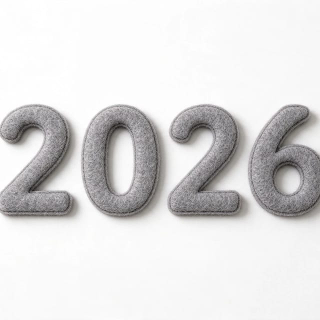 2026 numerals cut from warm grey wool felt