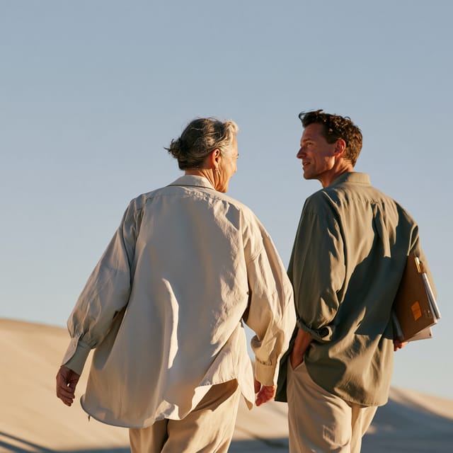 Two colleagues in conversation on a golden-hour walk
