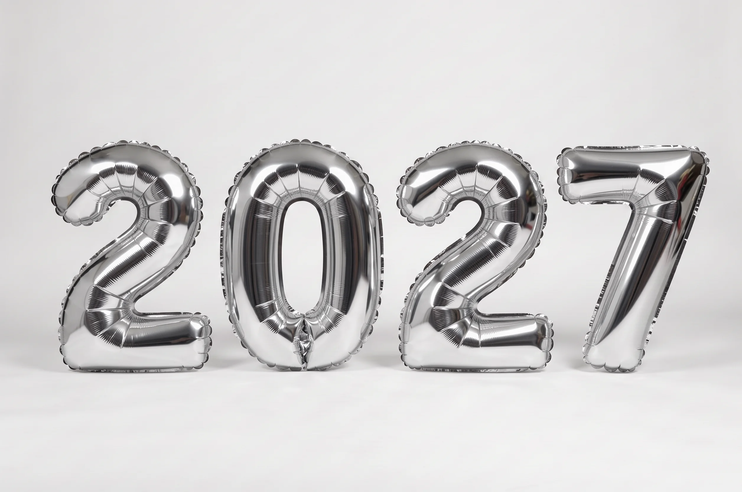 The numerals 2027 in crinkled silver foil balloons stand centered on a pure white background with a soft shadow.