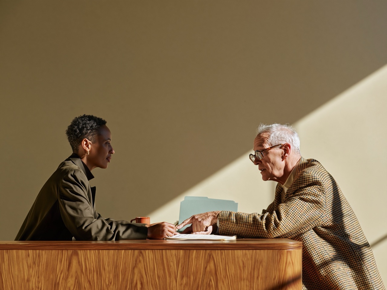 Accountant walking a client through a document across her desk