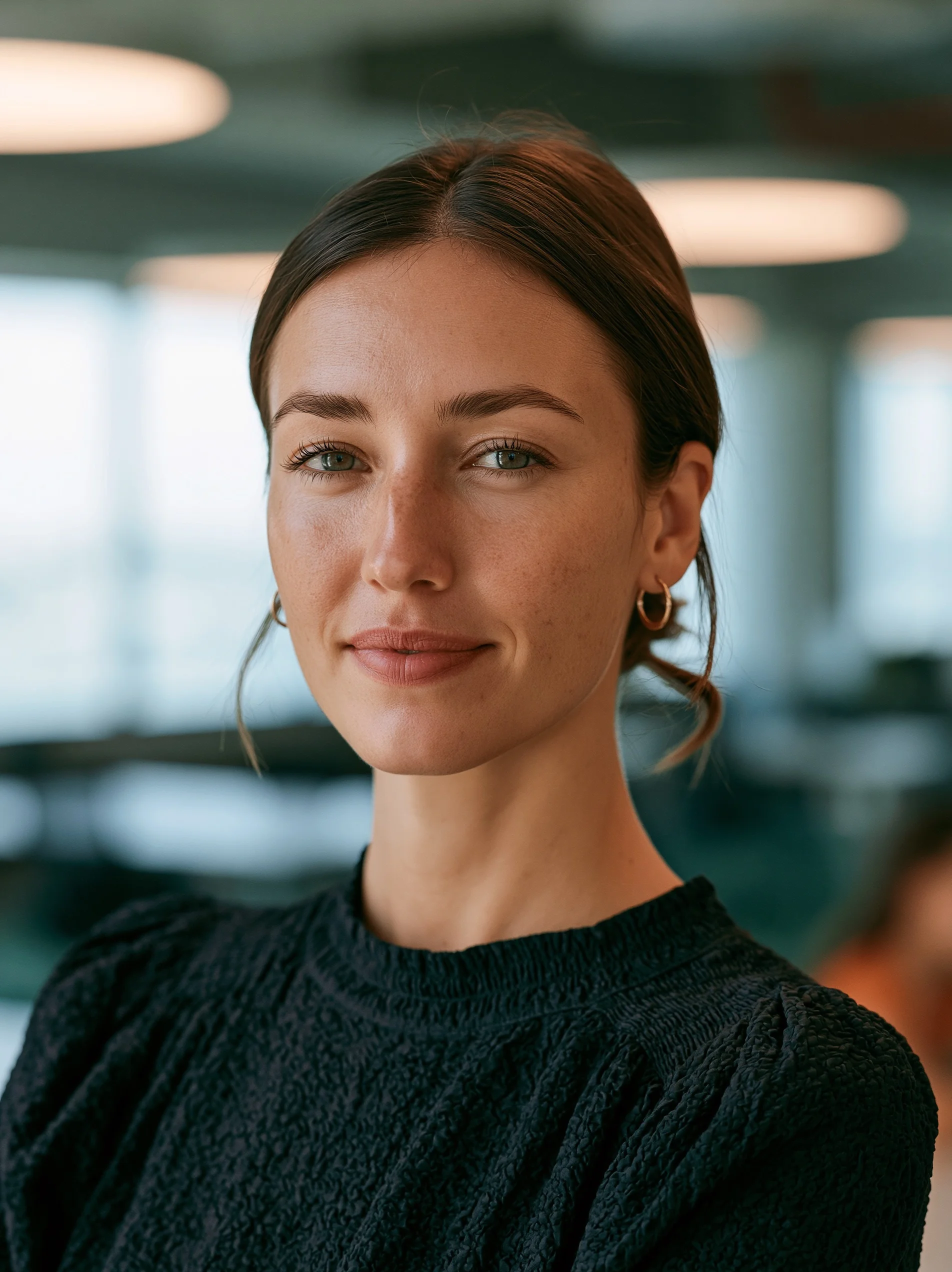 Sharp catchlights gleam in the eyes of an attentive HR manager during a professional corporate consultation in a warm-toned boardroom.