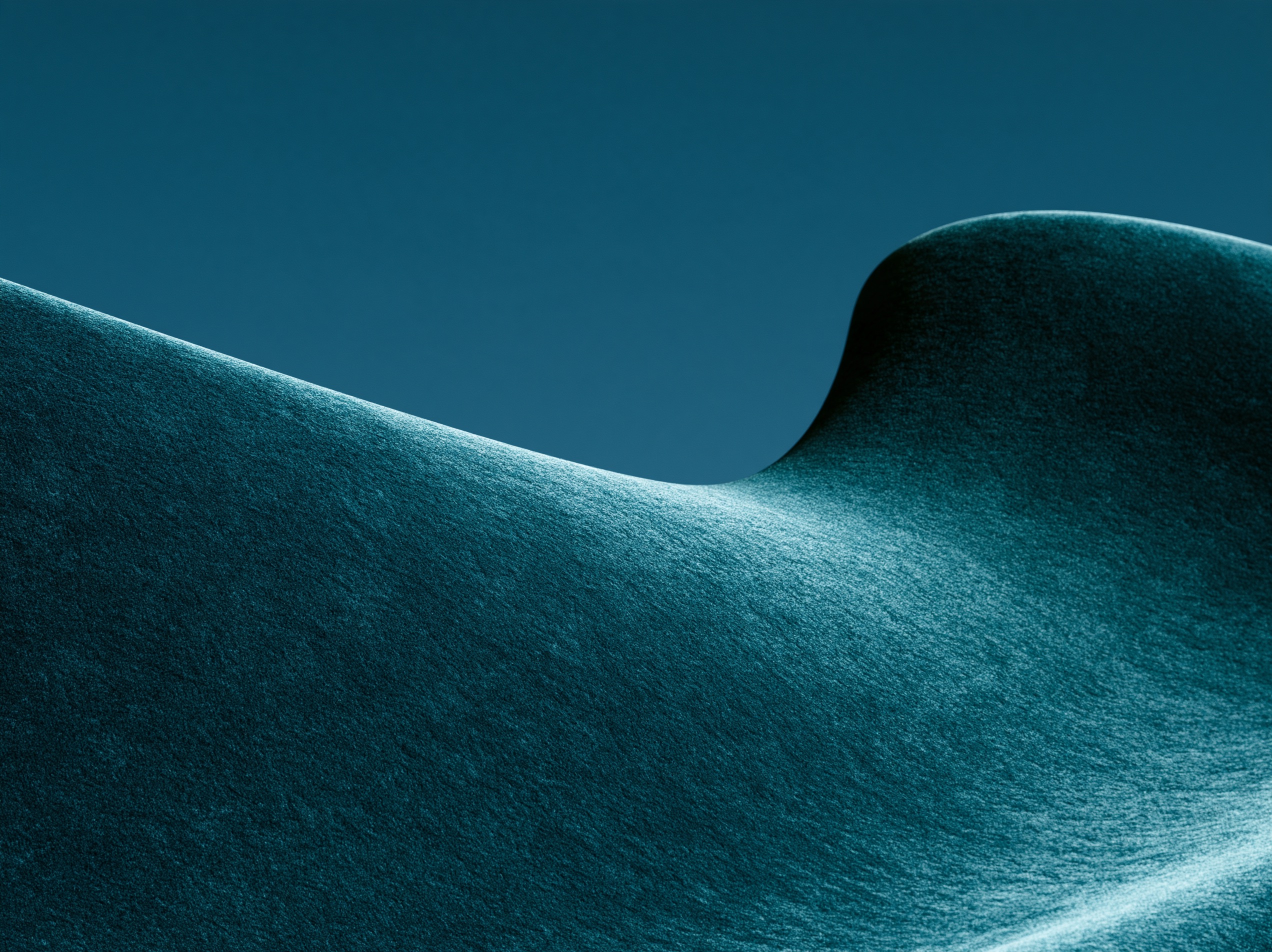 Minimalist abstract dunes with fine textured surfaces curve softly under directional light against a darkcyan background.