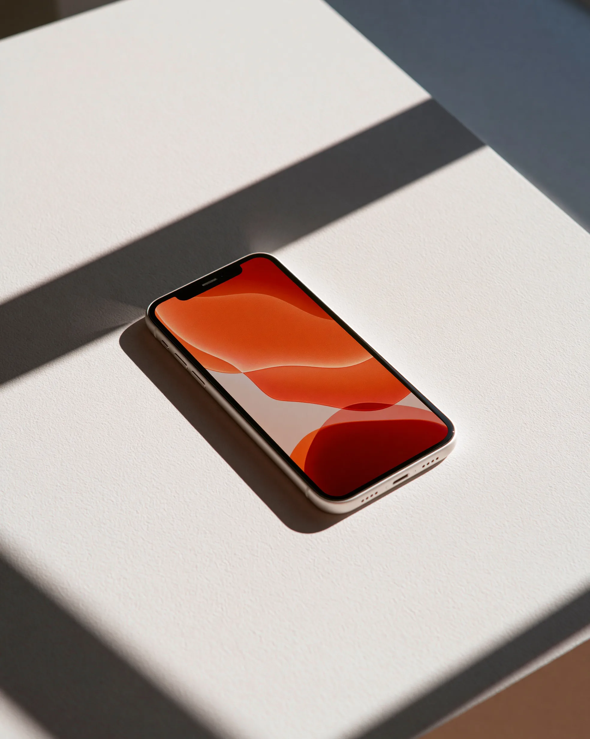 A clean iphone mockup on a white desk, its screen displaying a colorful app interface, with natural light casting a soft shadow.